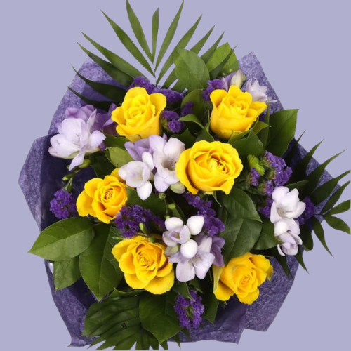 “Bouquet of yellow roses, lilac freesias, and purple flowers with greenery, wrapped in purple paper – under £35 UK flower delivery.”