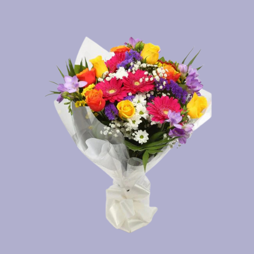 “Bright bouquet with yellow roses, pink gerberas, purple freesias, and white daisies wrapped in white paper – under £35 UK flower delivery.”