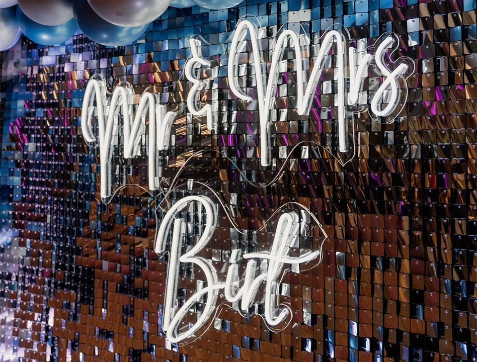 Custom “Mr & Mrs” LED neon sign on sequin shimmer wall backdrop – bespoke signage hire for UK weddings and corporate events