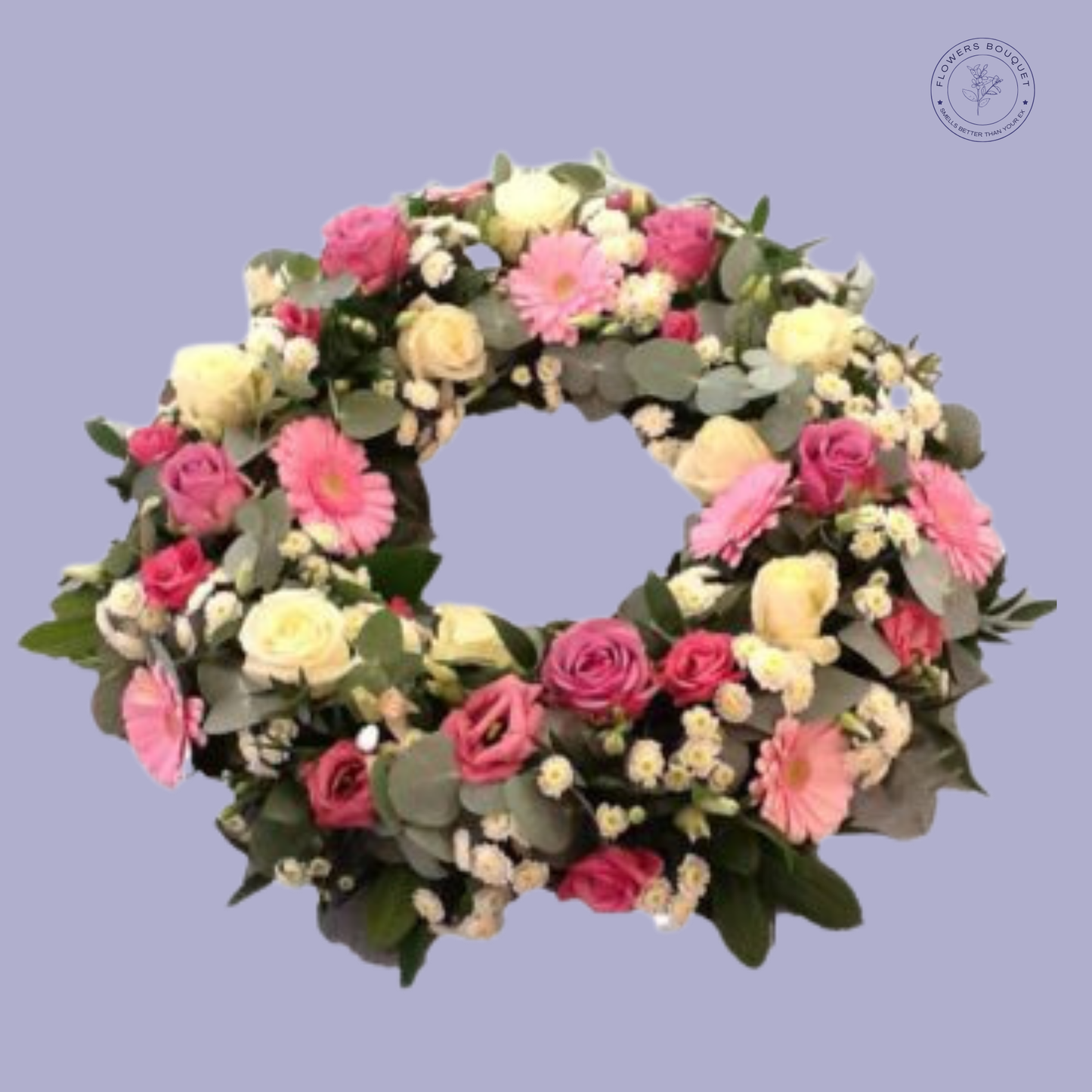 Elegant pastel funeral wreath featuring pink and ivory roses, gerberas, and lush greenery for a heartfelt tribute.