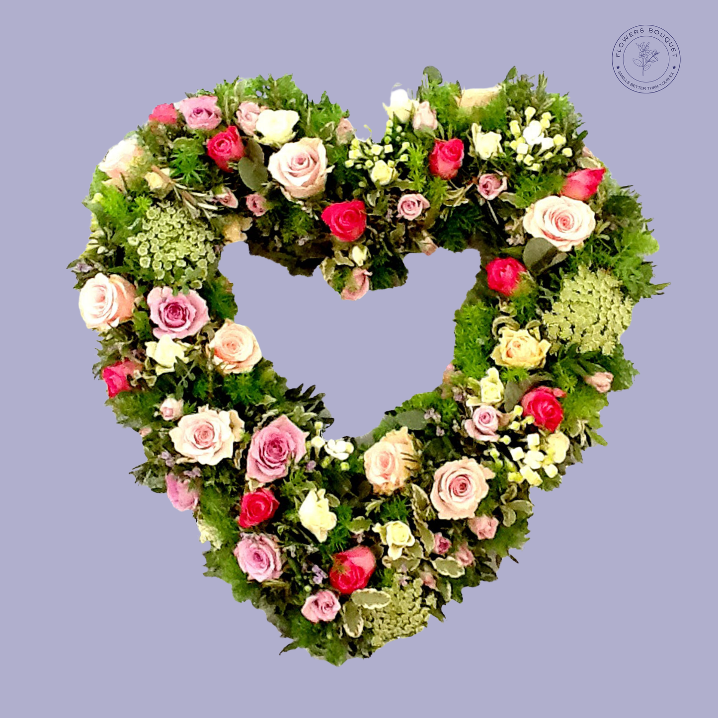Heart-shaped funeral tribute made with pink and red roses, surrounded by greenery.