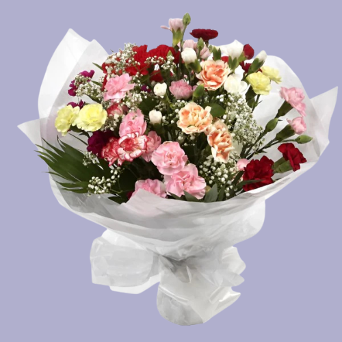 “Mixed carnation bouquet in pink, red, yellow, and peach tones with baby’s breath and greenery, wrapped in white paper – under £35 UK flowers.”