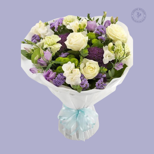 Purple Elegance Bouquet with white roses, purple roses, freesia, and limonium in a beautiful presentation.