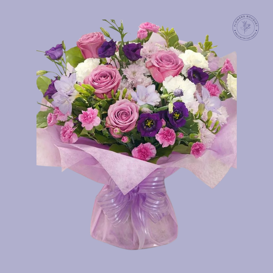Purple & Pink Roses Bouquet with carnations, lisianthus, and chrysanthemums, hand-tied with a satin bow.