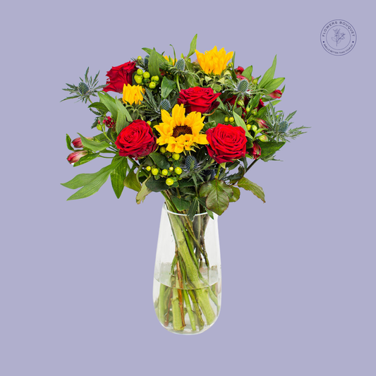 A bright Sunflower and Rose bouquet with vibrant sunflowers, red roses, and greenery.