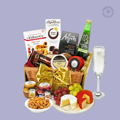  A luxurious gourmet hamper featuring premium cheeses, chocolates, shortbread, sparkling elderflower drink, nuts, and jams, tied with a golden bow.