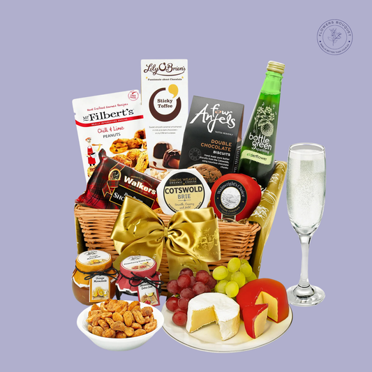  A luxurious gourmet hamper featuring premium cheeses, chocolates, shortbread, sparkling elderflower drink, nuts, and jams, tied with a golden bow.