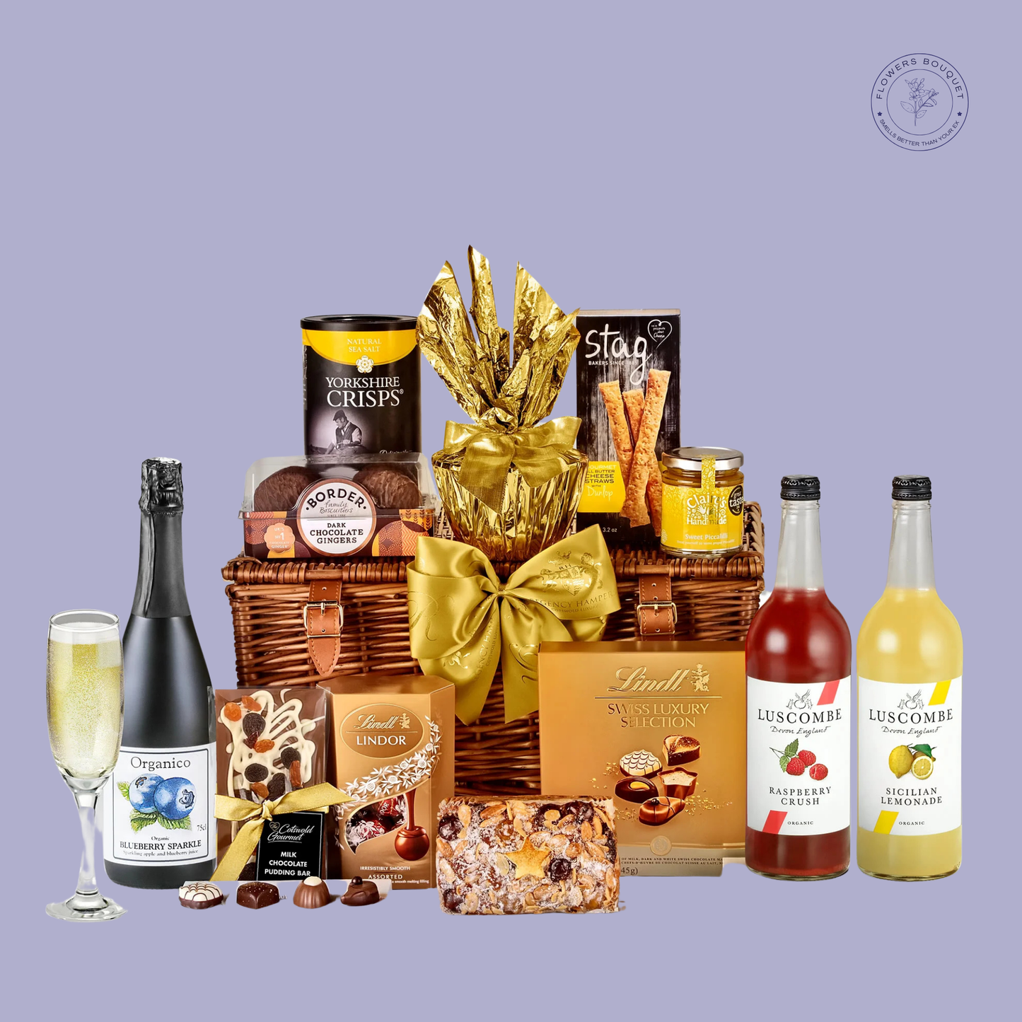 A luxurious wicker basket filled with Luscombe drinks, Swiss chocolates, Yorkshire crisps, festive cakes, and gourmet biscuits, tied with a golden ribbon for an elegant presentation.