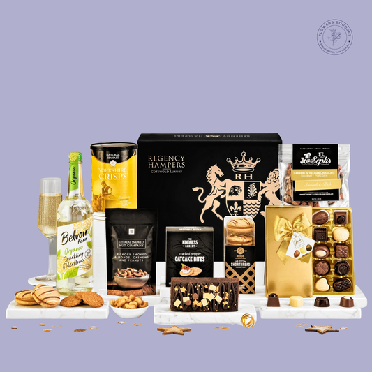 An elegant Regency Hamper featuring Belvoir Elderflower Sparkling Pressé, Yorkshire Crisps, luxurious chocolates, festive cake, gourmet snacks, and oatcake bites, displayed in a regal black and gold gift box.