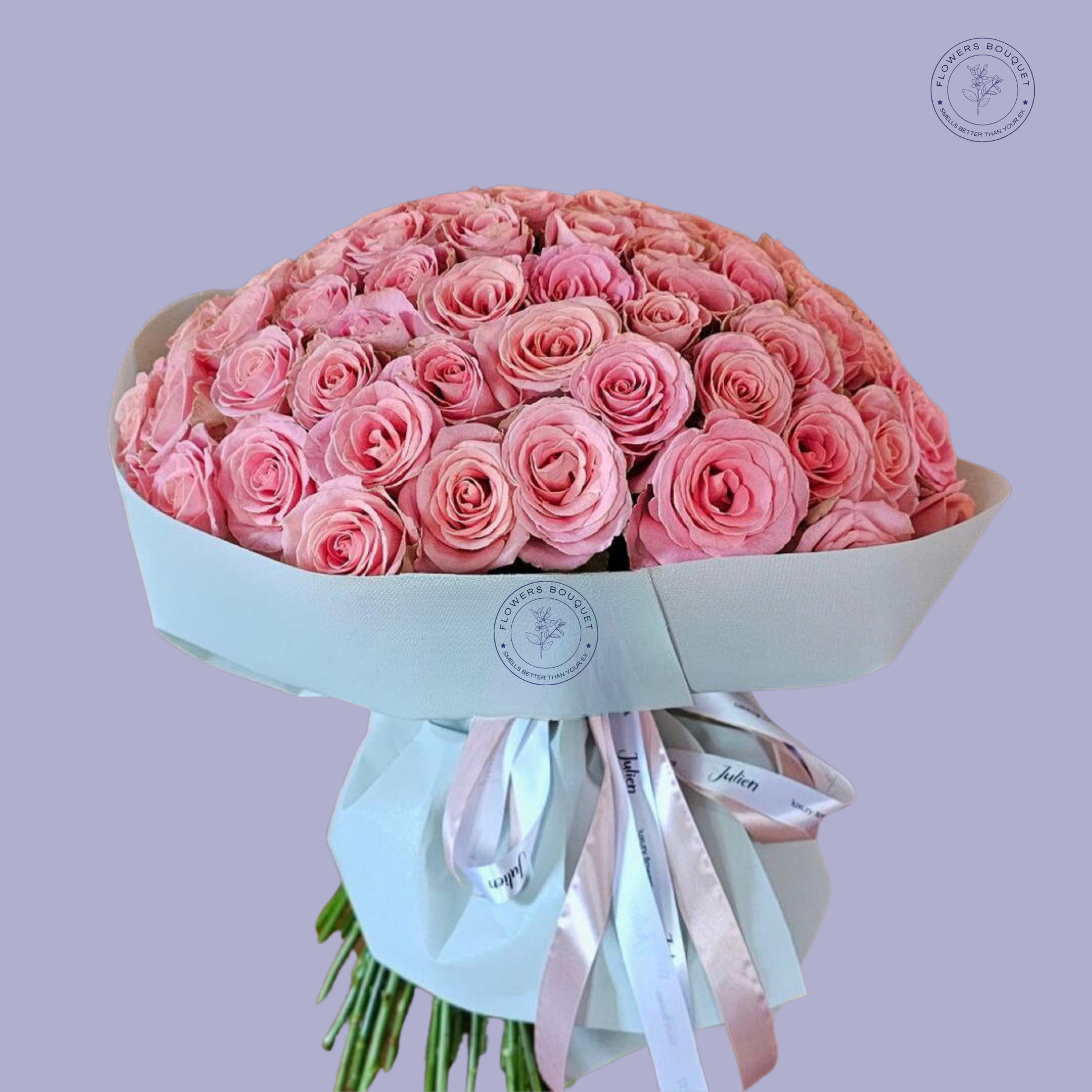 Blush Symphony bouquet featuring 50 premium pink roses elegantly wrapped in white luxury paper with satin ribbons.