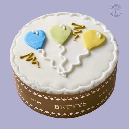Celebratory vanilla sponge cake with colorful fondant balloon decorations, perfect for birthdays and special occasions.