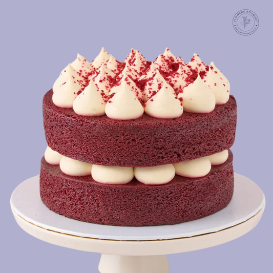 Classic Red Velvet Cake with cream cheese frosting and red velvet crumb topping, displayed on a white cake stand.