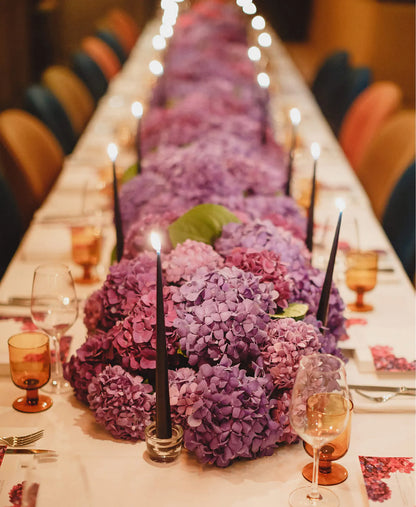 Elegant Floral Table Setting with Candles and Purple Orchids