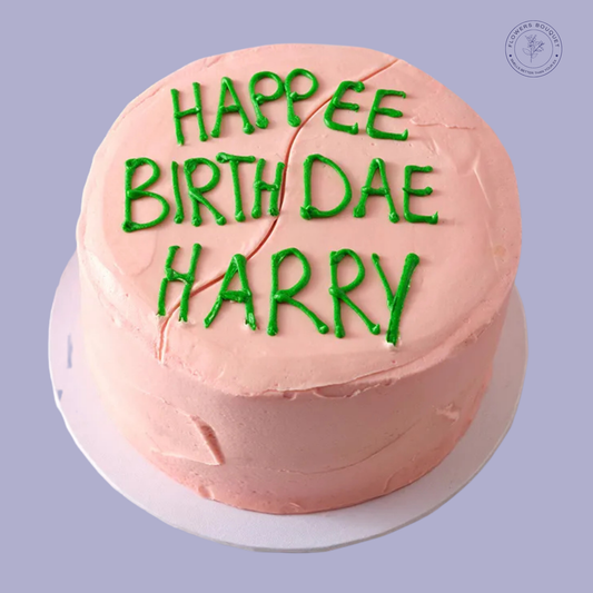 Happy Birthday Harry' themed cake with pastel pink buttercream and green piping, perfect for wizarding fans.