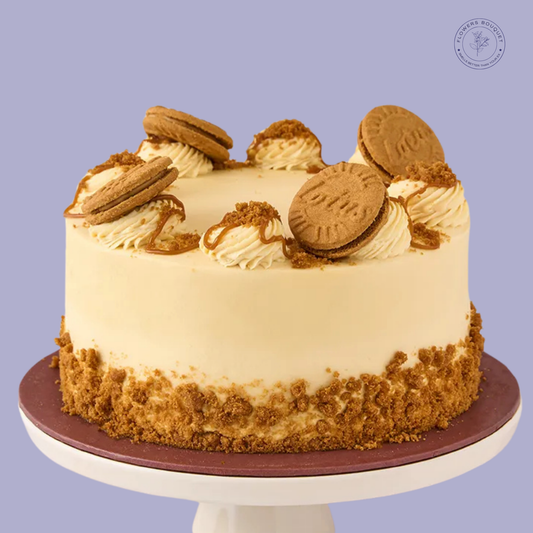 Lotus Biscoff birthday cake with buttercream frosting, Biscoff biscuits, crushed crumbs, and caramel drizzle. Perfect for celebrations.