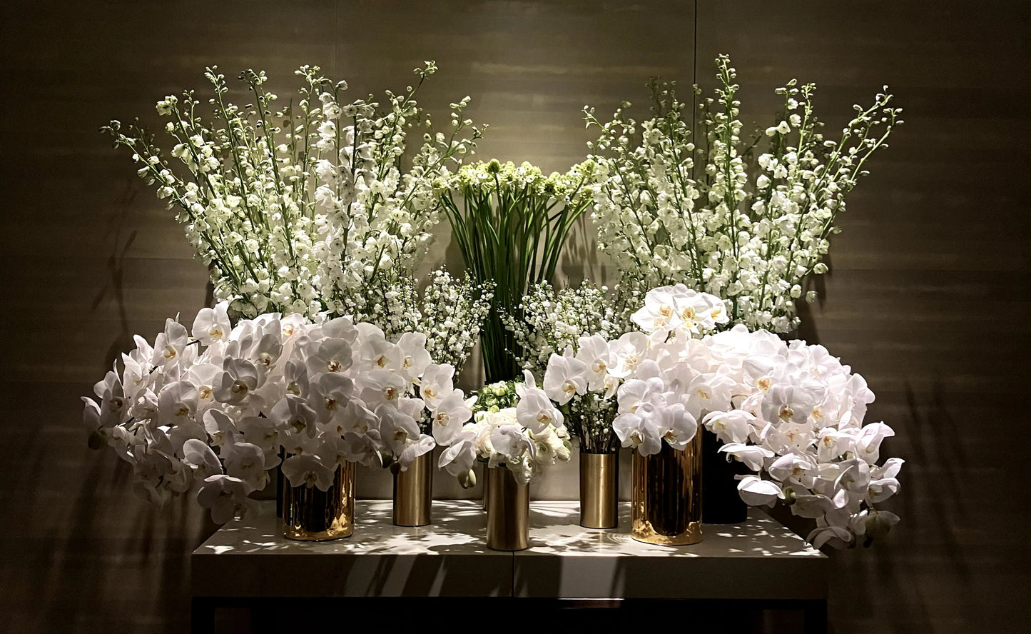 White Orchid and floral arrangement in gold vases, ideal for luxury event decor.