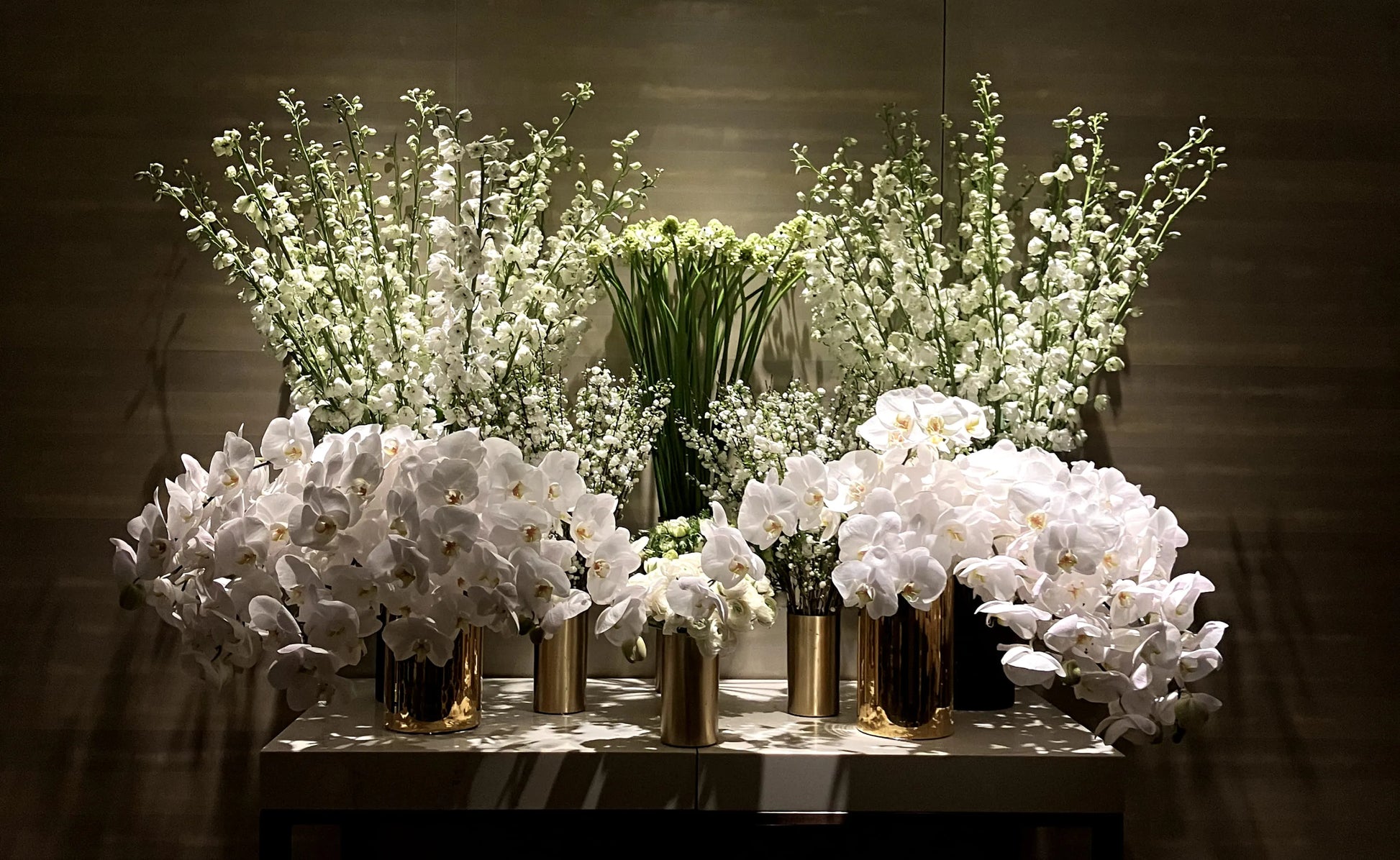 White Orchid and floral arrangement in gold vases, ideal for luxury event decor.