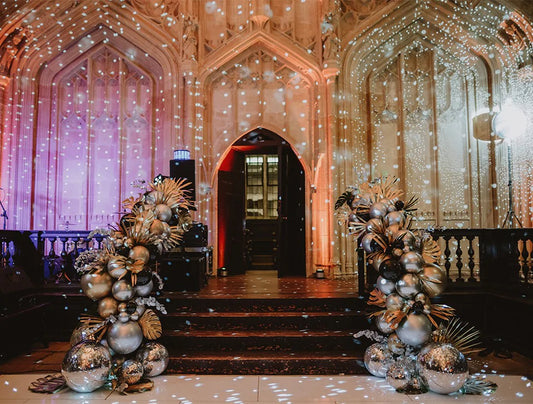 Luxury corporate event balloon display in silver and gold with entrance stage backdrop – premium balloon installation for UK events