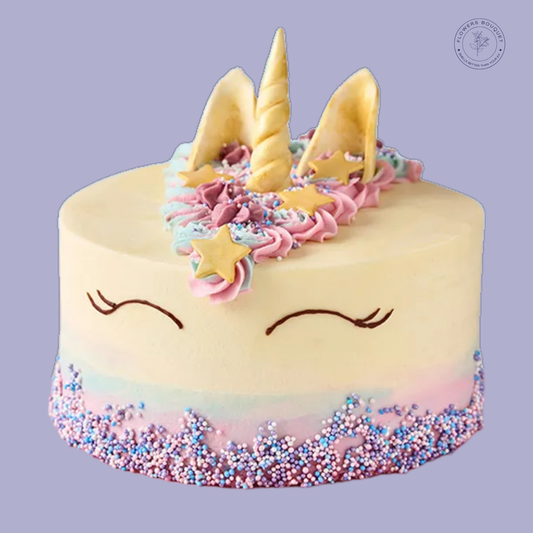 Magical unicorn-themed cake with pastel buttercream, golden edible horn, and star decorations, perfect for birthdays and special celebrations.