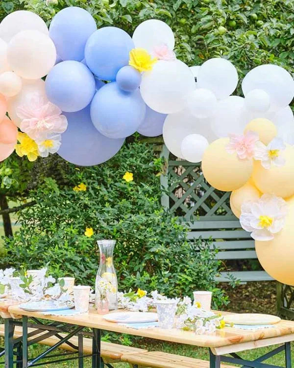 Pastel Blossom Balloon Arch with pastel balloons and flower accents, ideal for outdoor garden parties, weddings, and baby showers.