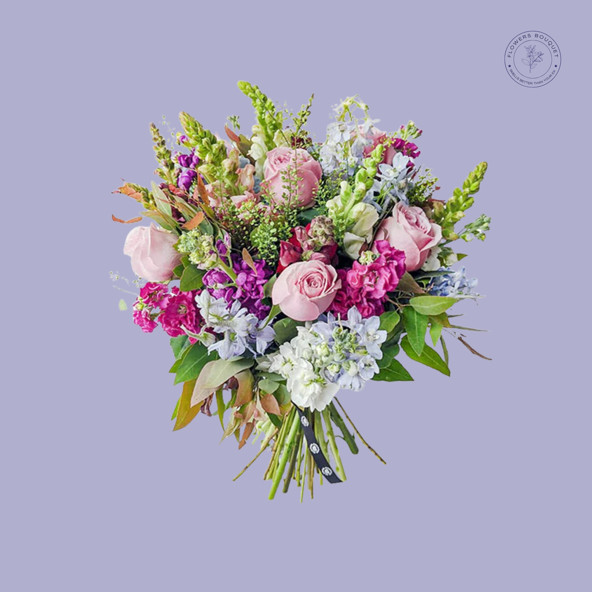 Pastel mixed bouquet with pink roses, purple snapdragons, and white stock flowers in a clear vase.
