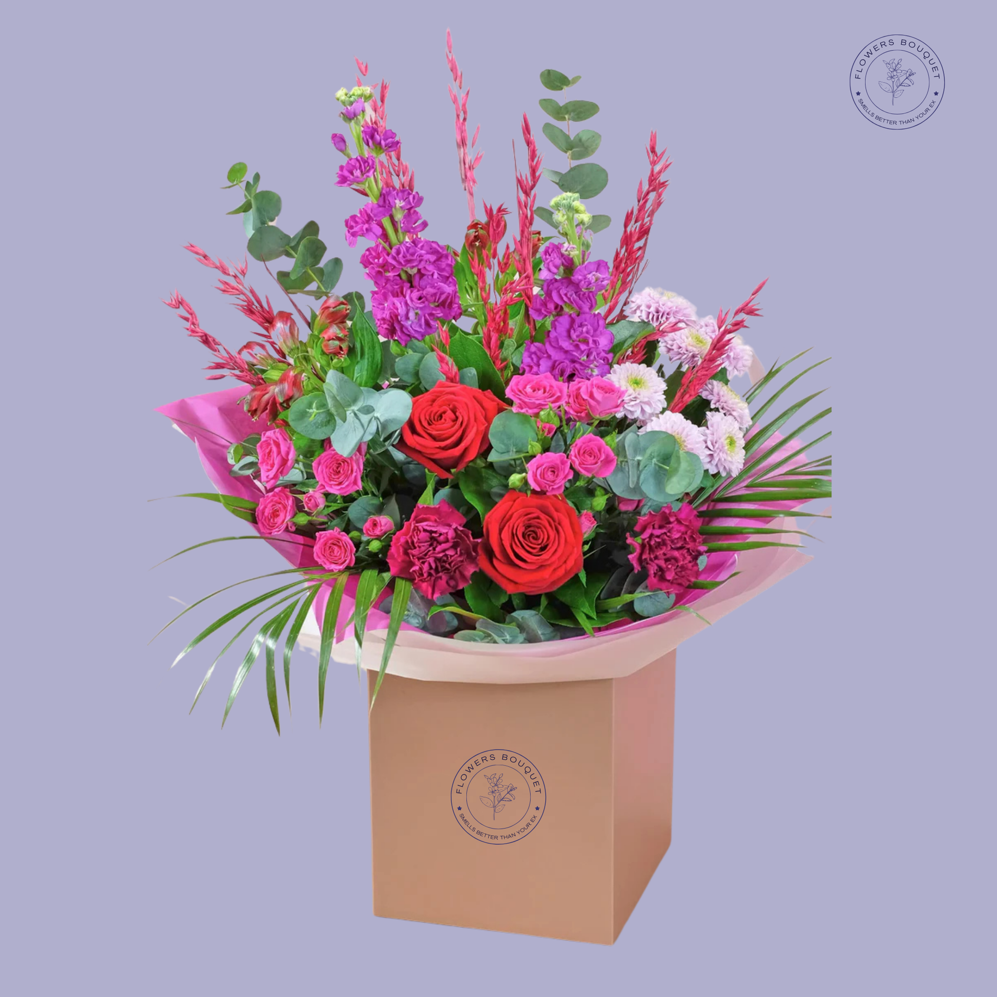 Radiant Bliss Bouquet with red roses, pink spray roses, purple stock flowers, carnations, and eucalyptus in a luxurious gift bag.