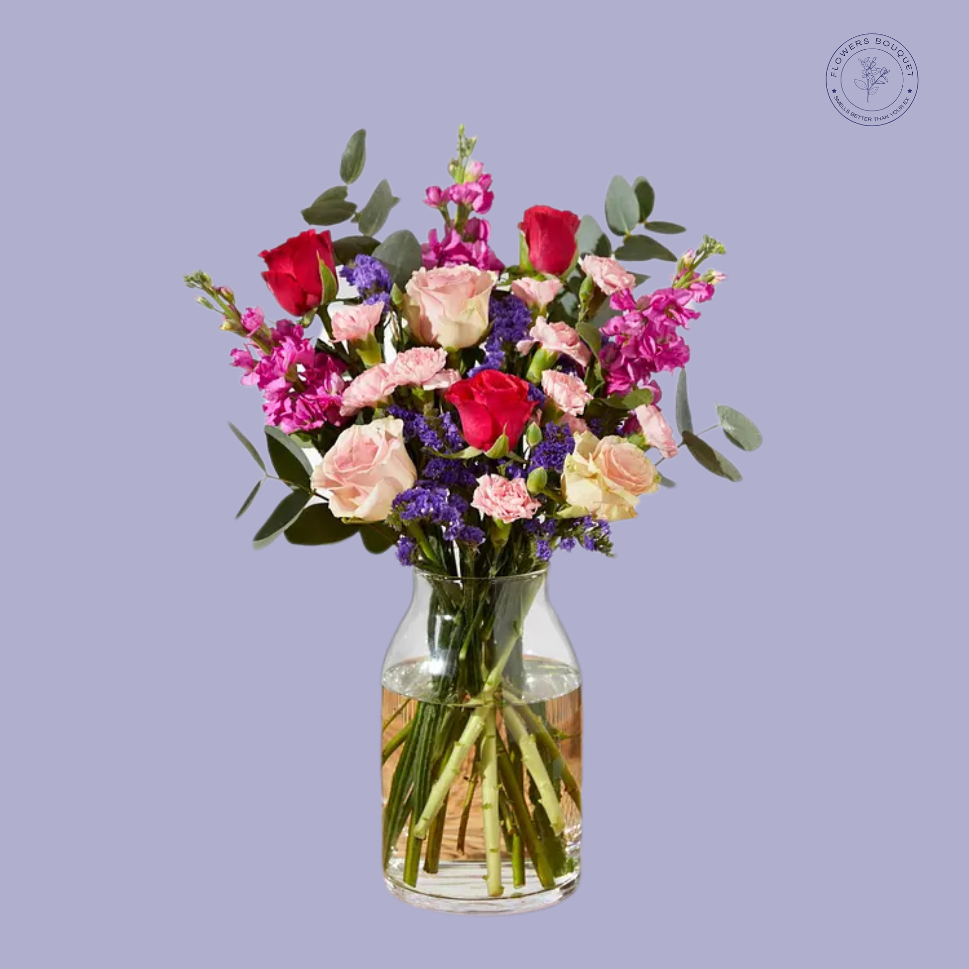 Romantic Bliss floral arrangement with red and pink roses, snapdragons, carnations, limonium, and eucalyptus in a clear glass vase.