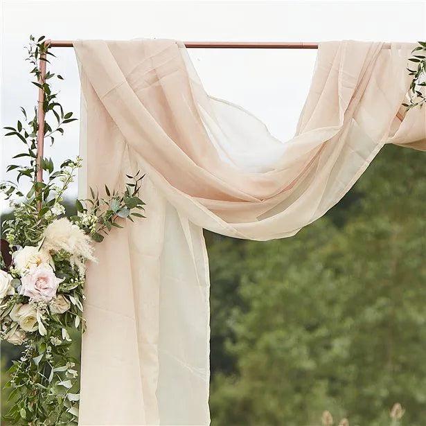 Rustic wedding arch with ivory drapes, greenery, and white roses – perfect for outdoor UK wedding ceremony decoration.