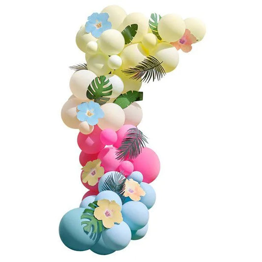Tropical balloon garland arch with pastel balloons, floral accents, and tropical leaves for garden party decoration