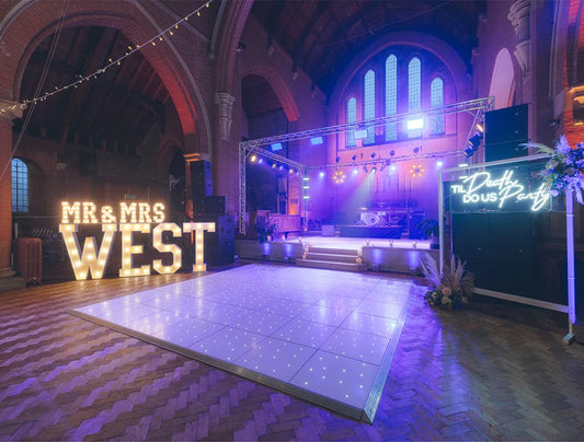 White LED dance floor with star lighting setup at wedding event – premium dance floor hire for UK corporate and luxury celebrations

