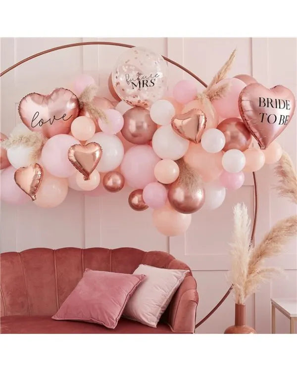 Rose gold bridal balloon arch kit with blush pink and white balloons, pampas accents, and “Bride to Be” heart foil – perfect for bridal shower décor.