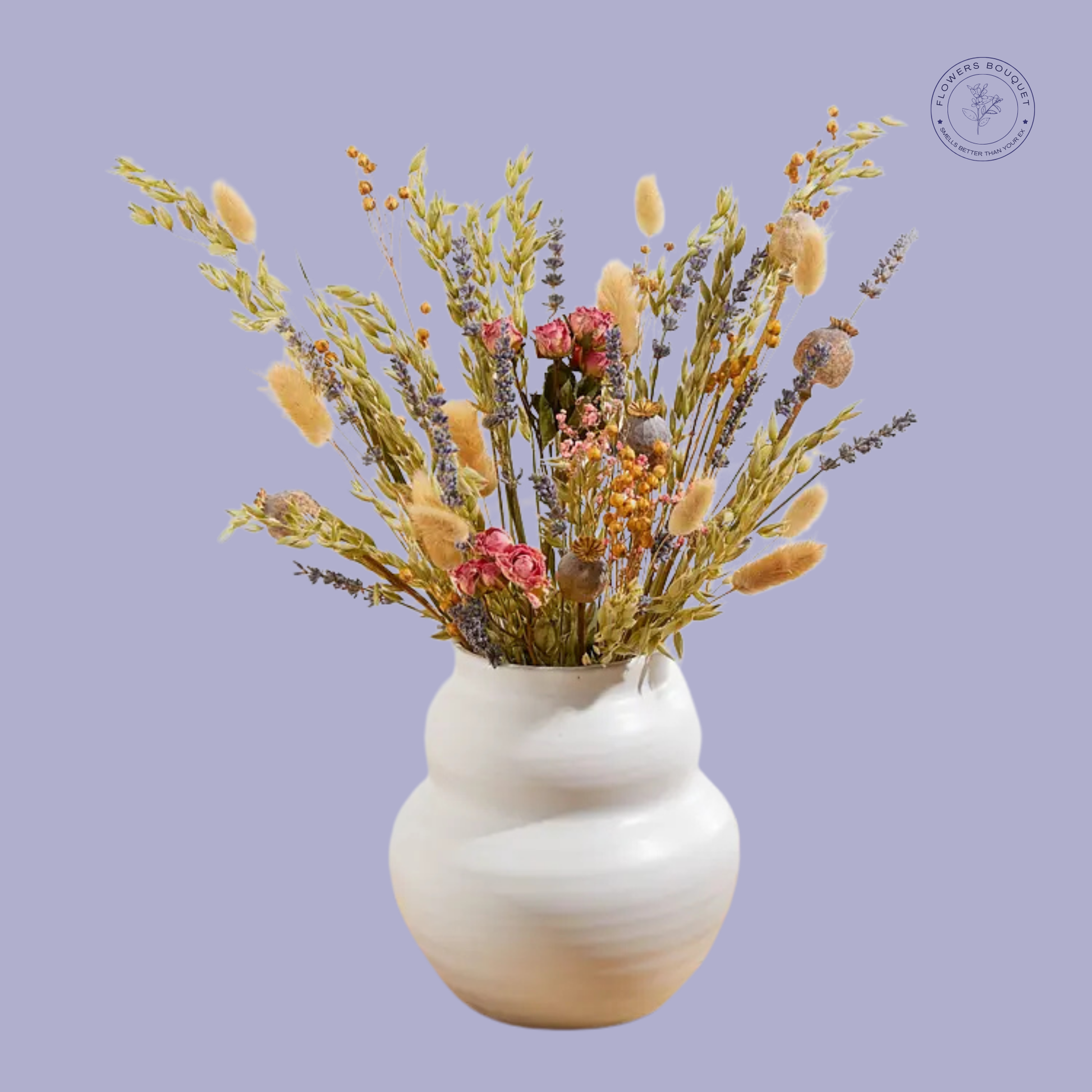 A rustic dried flower arrangement featuring lavender, bunny tails, preserved roses, oats, and poppy pods in a white ceramic vase.